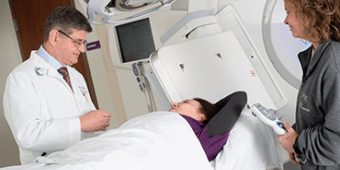 Physicist with patient